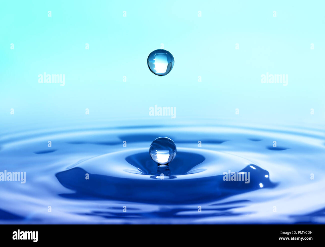 Splash closeup. Drop of rain fall on smooth water surface Stock Photo