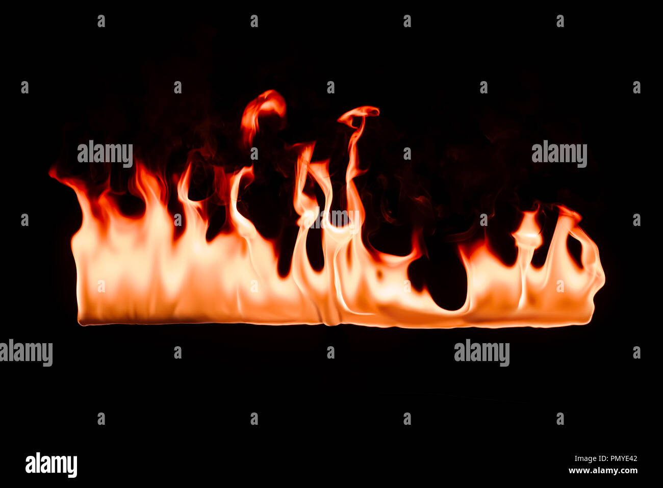 close up view of burning orange fire on black background Stock Photo