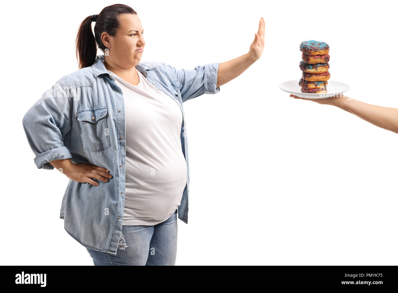 Overweight woman refusing to eat donuts isolated on white background Stock Photo