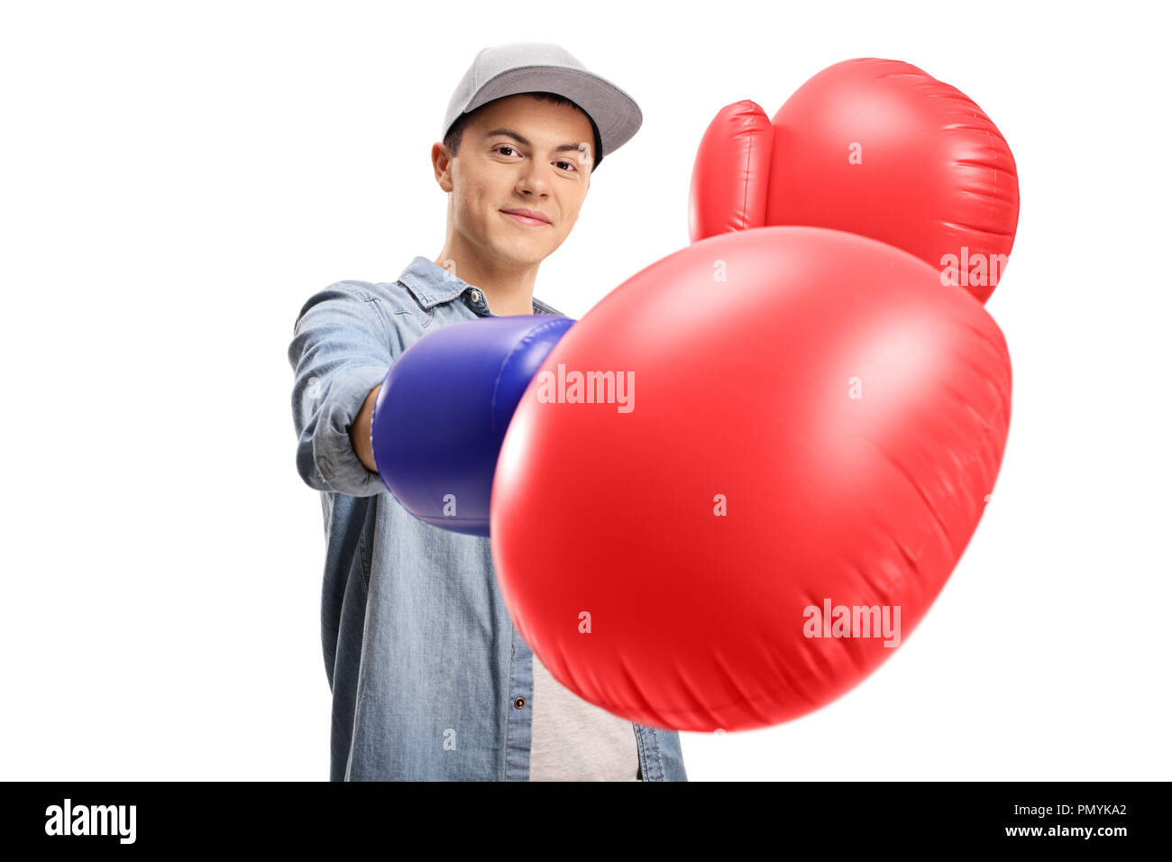 Teenage boy wearing a pair of big boxing gloves isolated on white