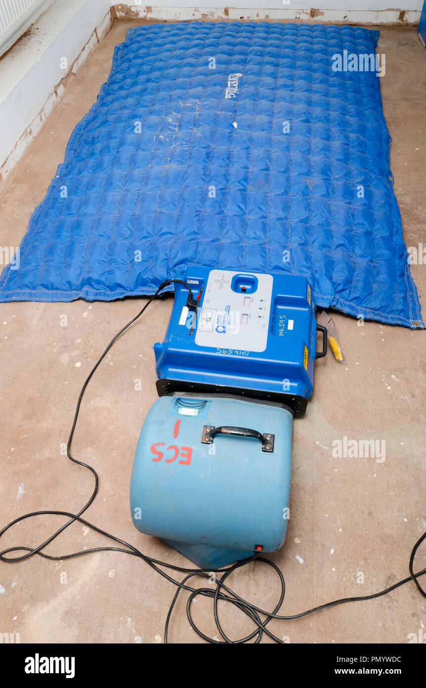 Drying flooded property concrete floor with Direct Air Dryer mat. Stock Photo
