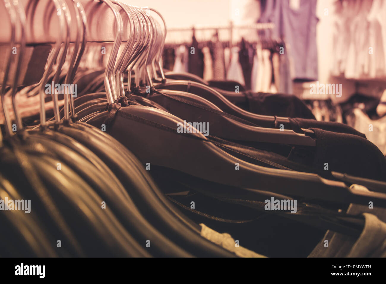 Close up of many clothes on hangers in a clothing shop. Stock Photo