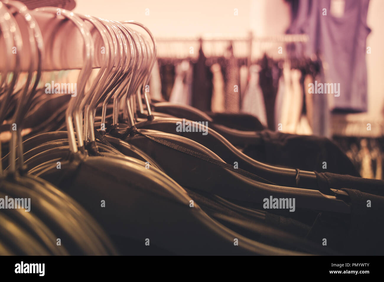 Close up of many clothes on hangers in a clothing shop. Stock Photo