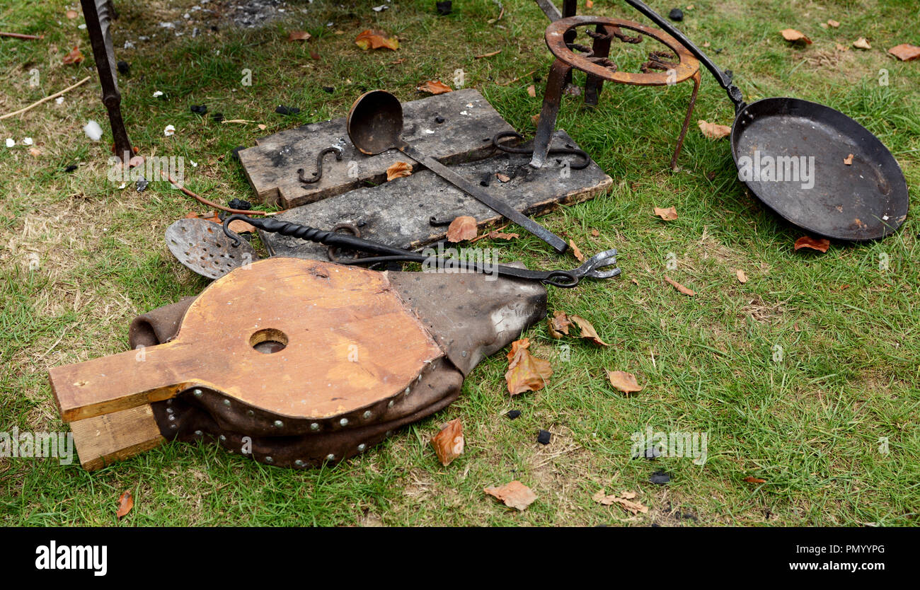 Bellows, ladle, poker and frying pan - authentic campfire details at a Medieval Fair Stock Photo