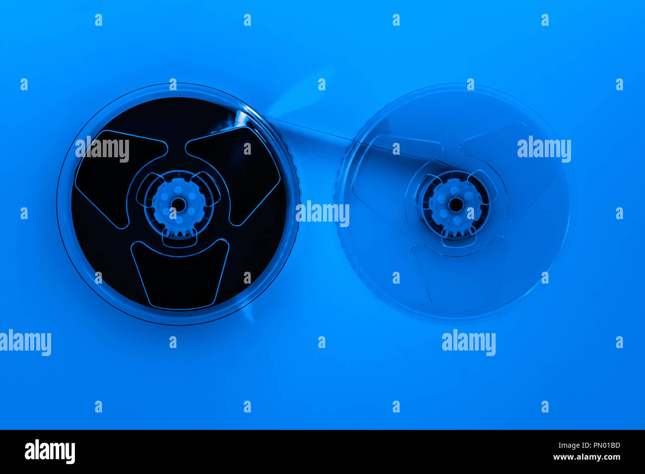 Abstract composition of video home system VHS tape reels in blue color effect Stock Photo