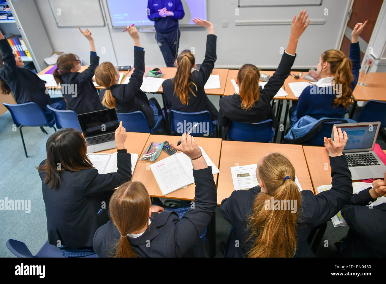 Students raise their hands in class at Royal High School Bath, which is