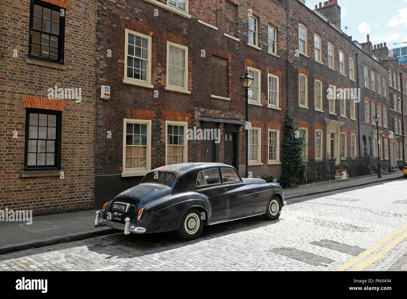 Classic vintage black 1950s Bentley car parked outside row of terraced houses on Elder Street in Spitalfields East London  E1 UK,  KATHY DEWITT Stock Photo