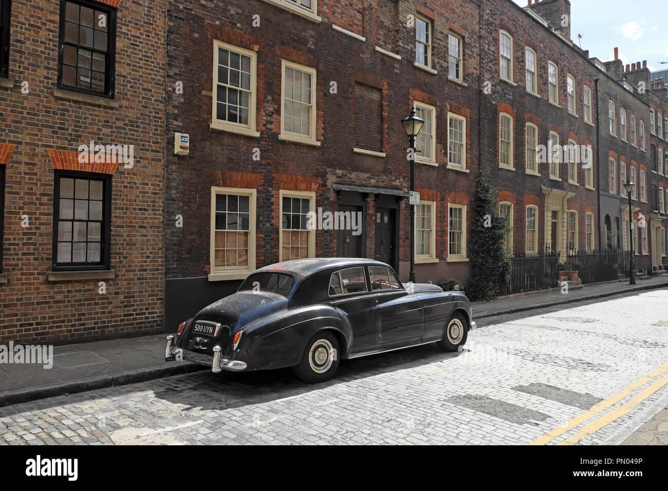 Classic vintage black 1950s Bentley car parked outside row of terraced ...