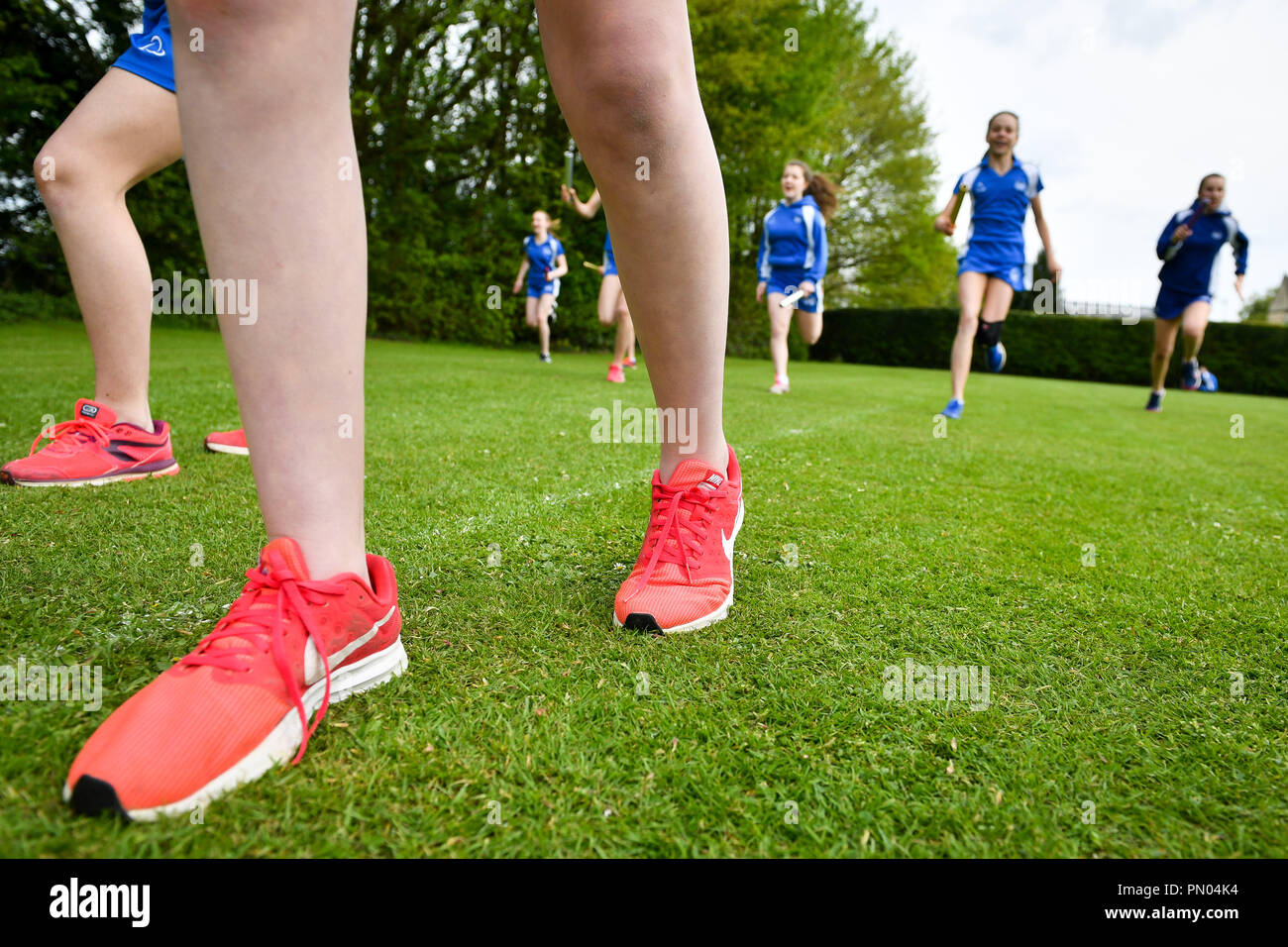 Students run during a Physical Education (PE) lesson on the school playing field at Royal High School Bath, which is a day and boarding school for girls aged 3-18 and also part of The Girls' Day School Trust, the leading network of independent girls' schools in the UK. Stock Photo