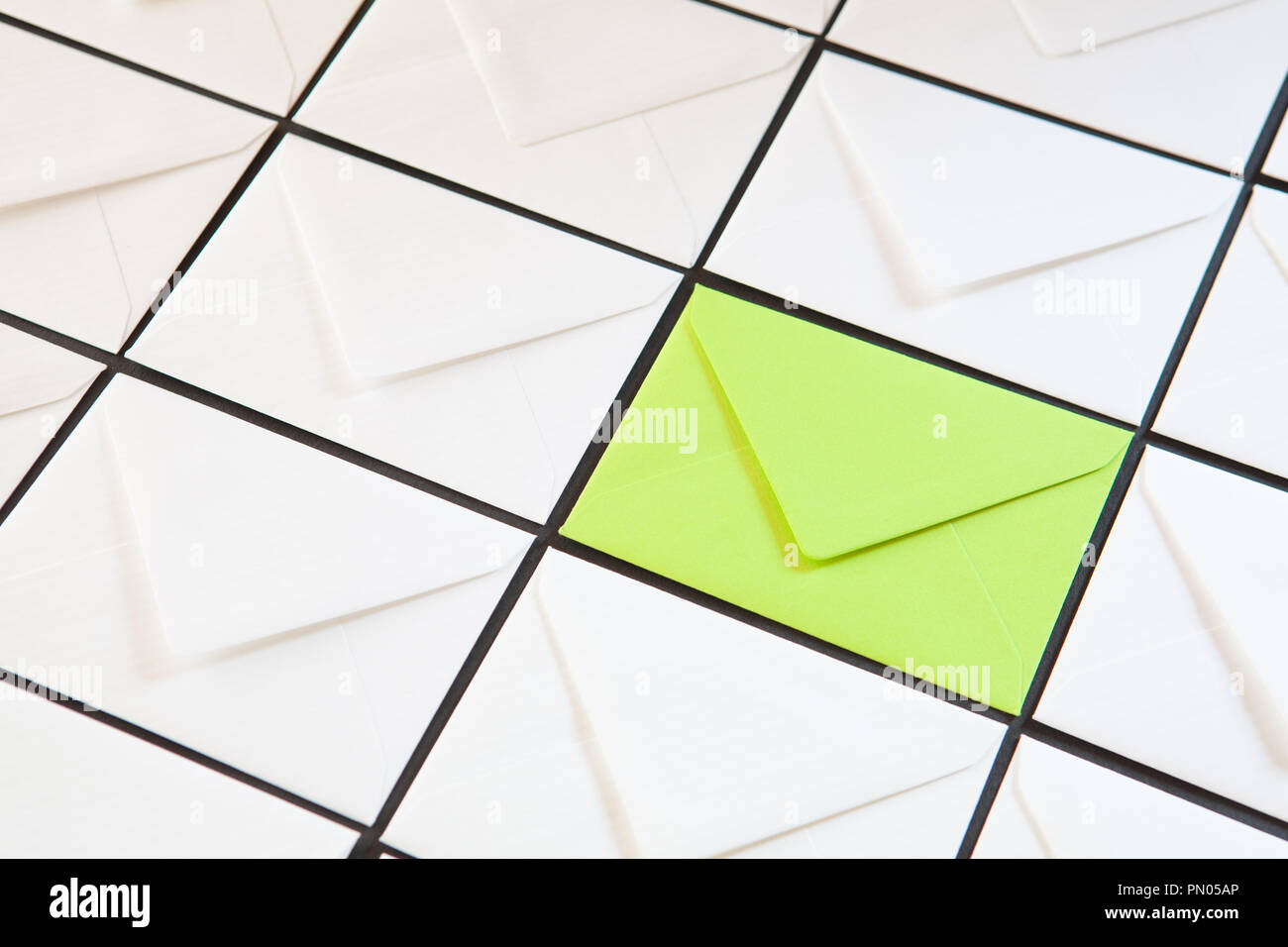 Composition with white and green envelopes on the table. Different colored envelopes on the table. Stock Photo