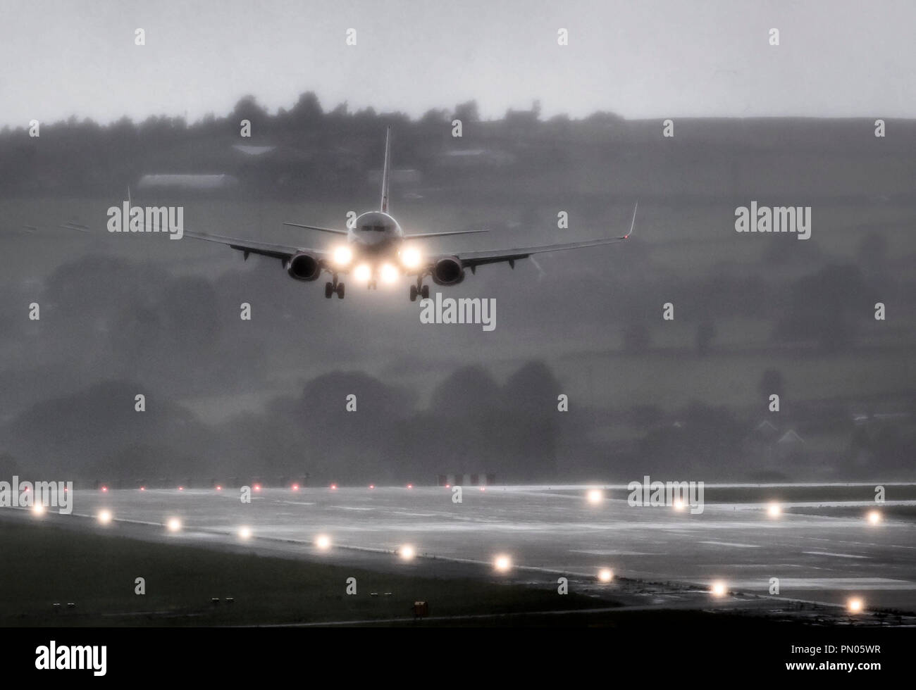 A plane lands in torrential rain at Leeds Bradford Airport as Storm Ali hits the UK. Stock Photo