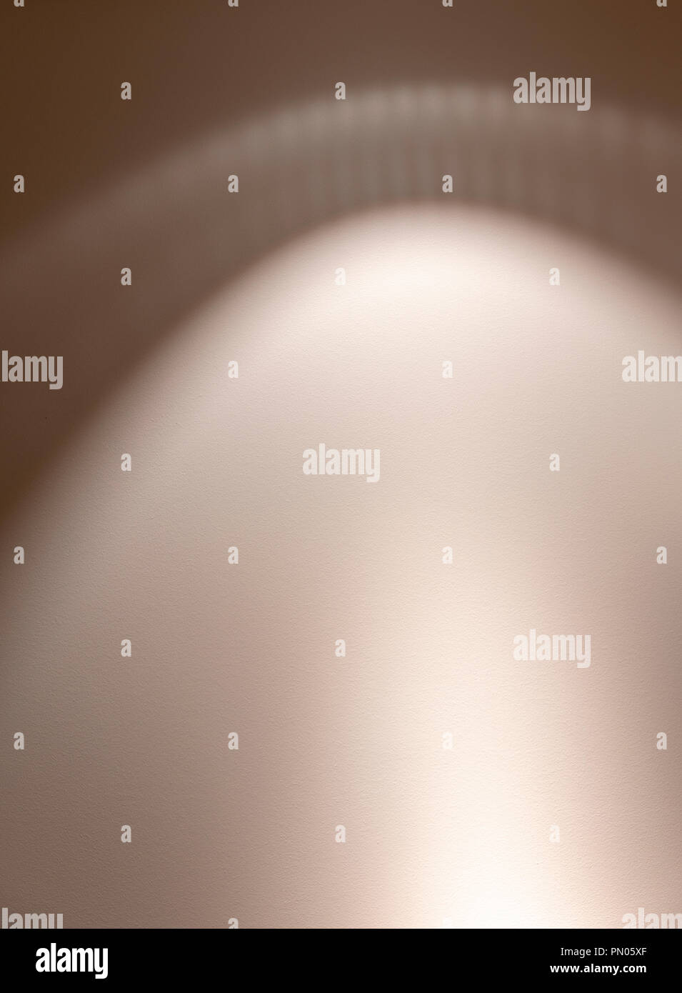 Patterns on wall cast by light onto painted wall. Stock Photo