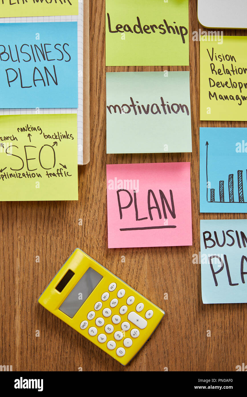 top view of paper stickers with business strategy and calculator on tabletop Stock Photo Alamy