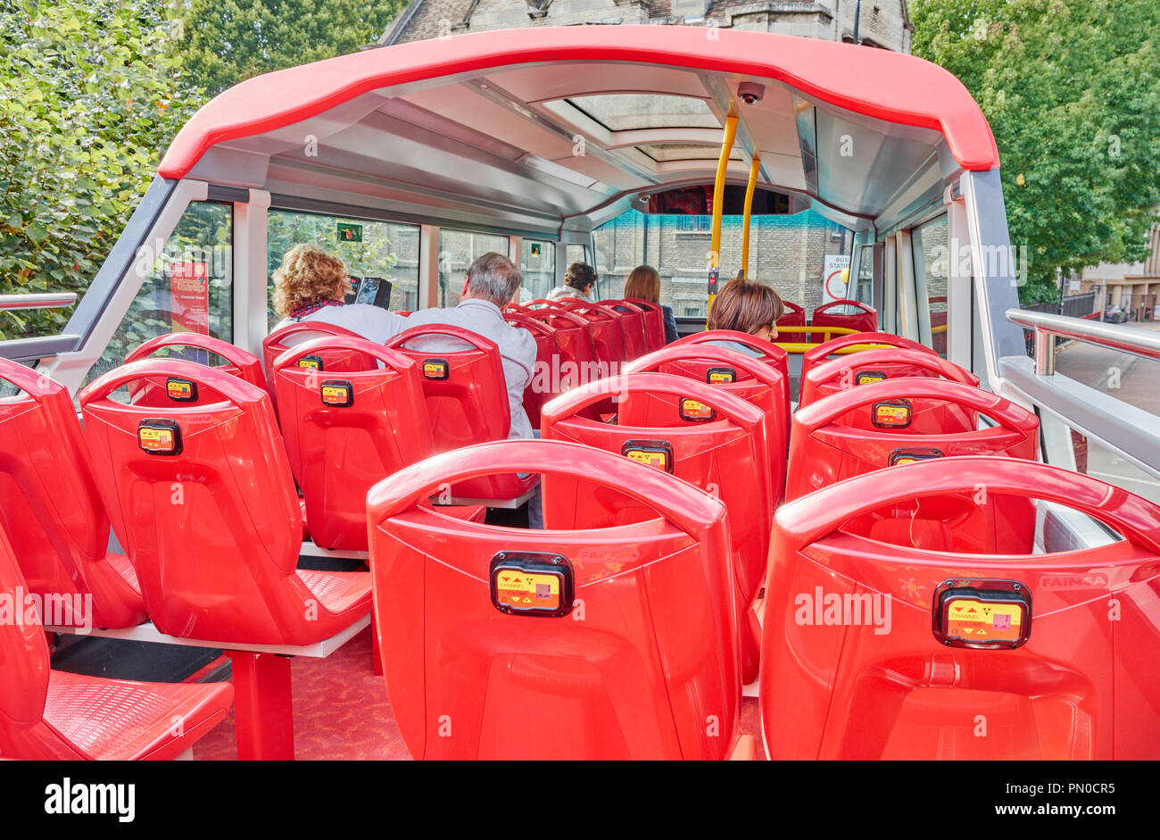 The upper deck of a hop-on, hop-off, sightseeing red double decker bus at Cambridge, England Stock Photo