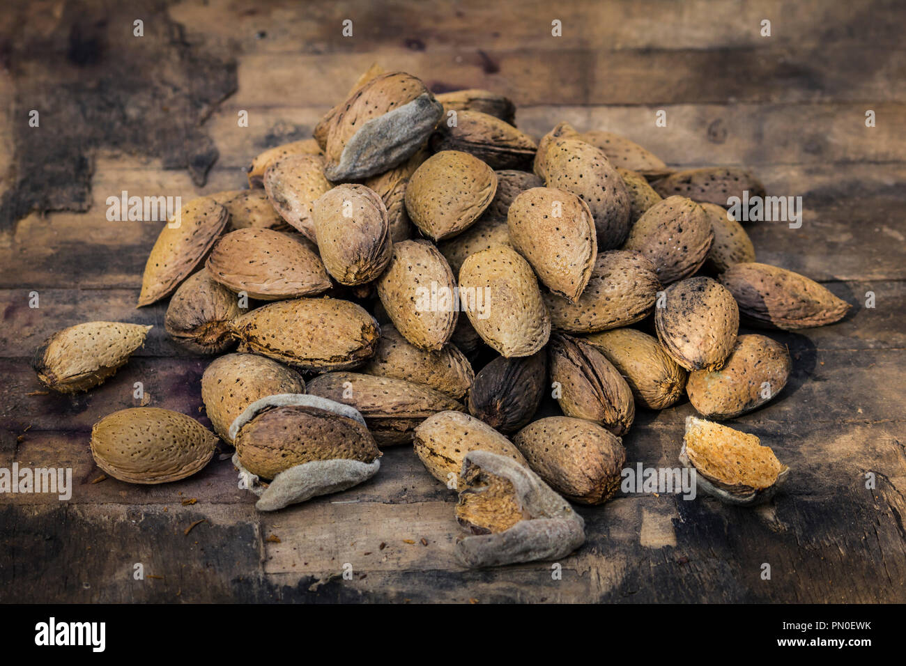 Almonds on an old and rustic wood table Stock Photo