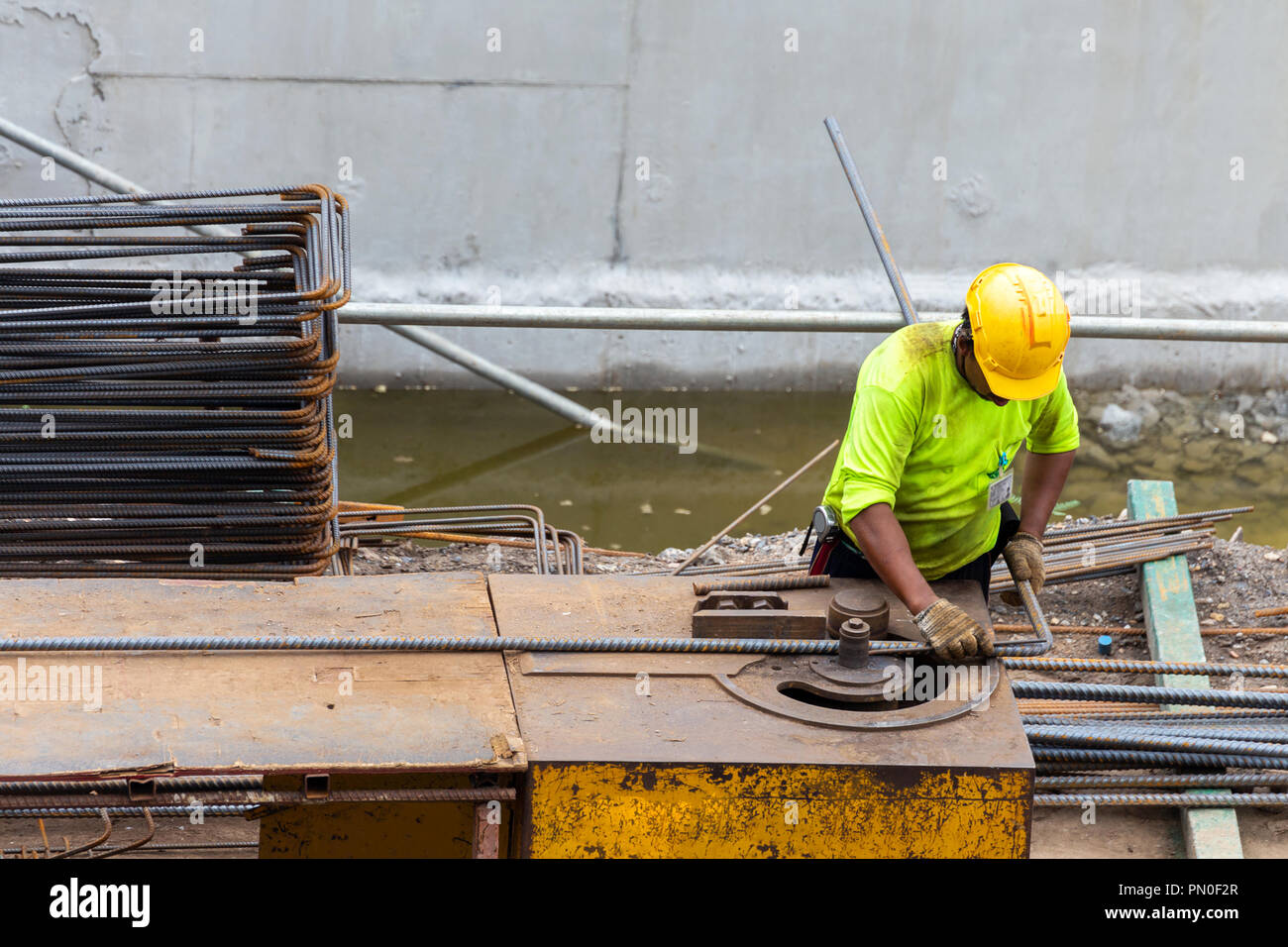 asian construction worker is using steel bending machine bender rebar