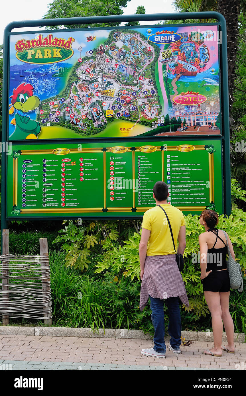 Italy, Lombardy, Lake Garda, Gardaland, couple reading the map. Stock Photo