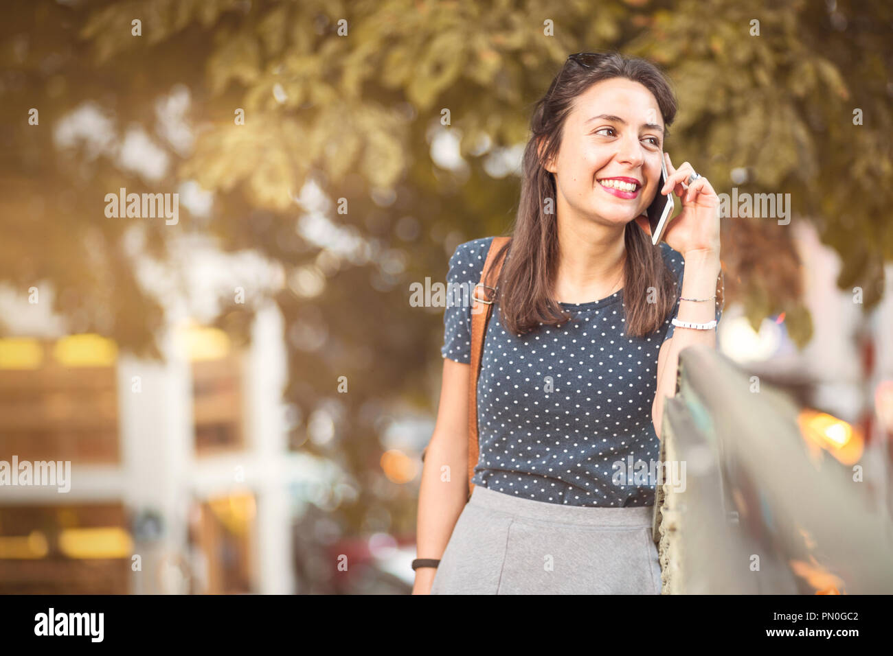 Young, happy woman listening to a cell phone call Stock Photo
