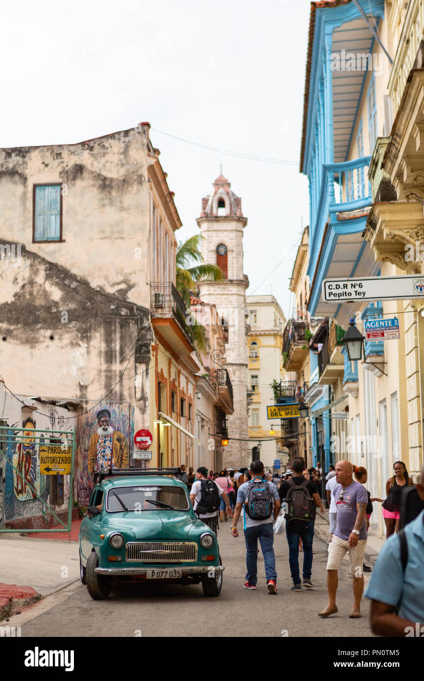 City street scene with green classic car, Havana, Cuba Stock Photo