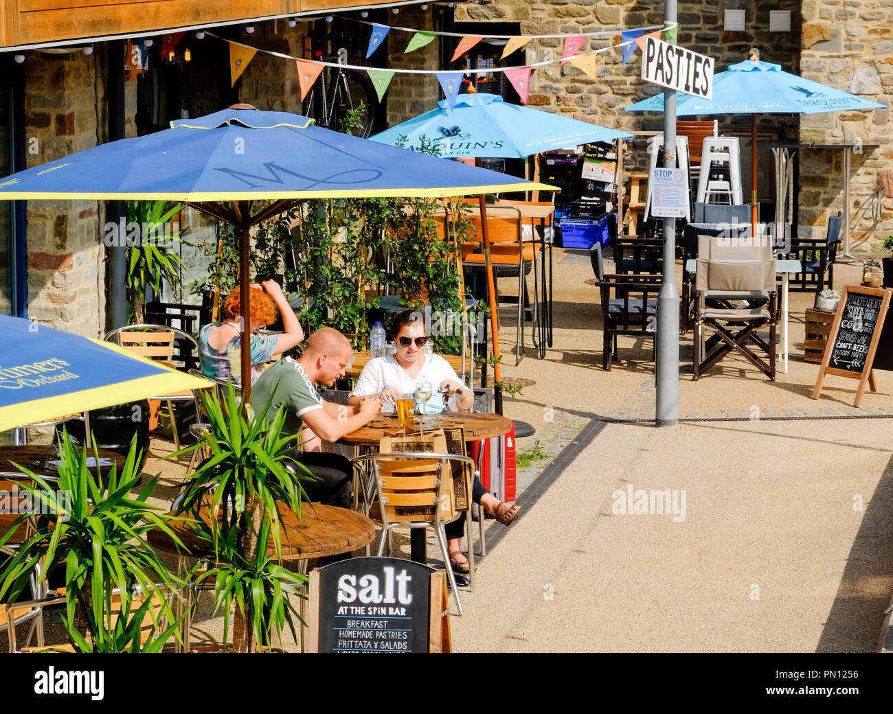 Affluent settings around Bristol Harbourside, a pavement cafe in summer Stock Photo