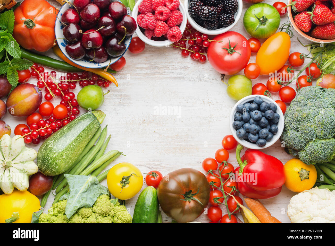 Healthy summer fruits vegetables berries arranged in a circle frame