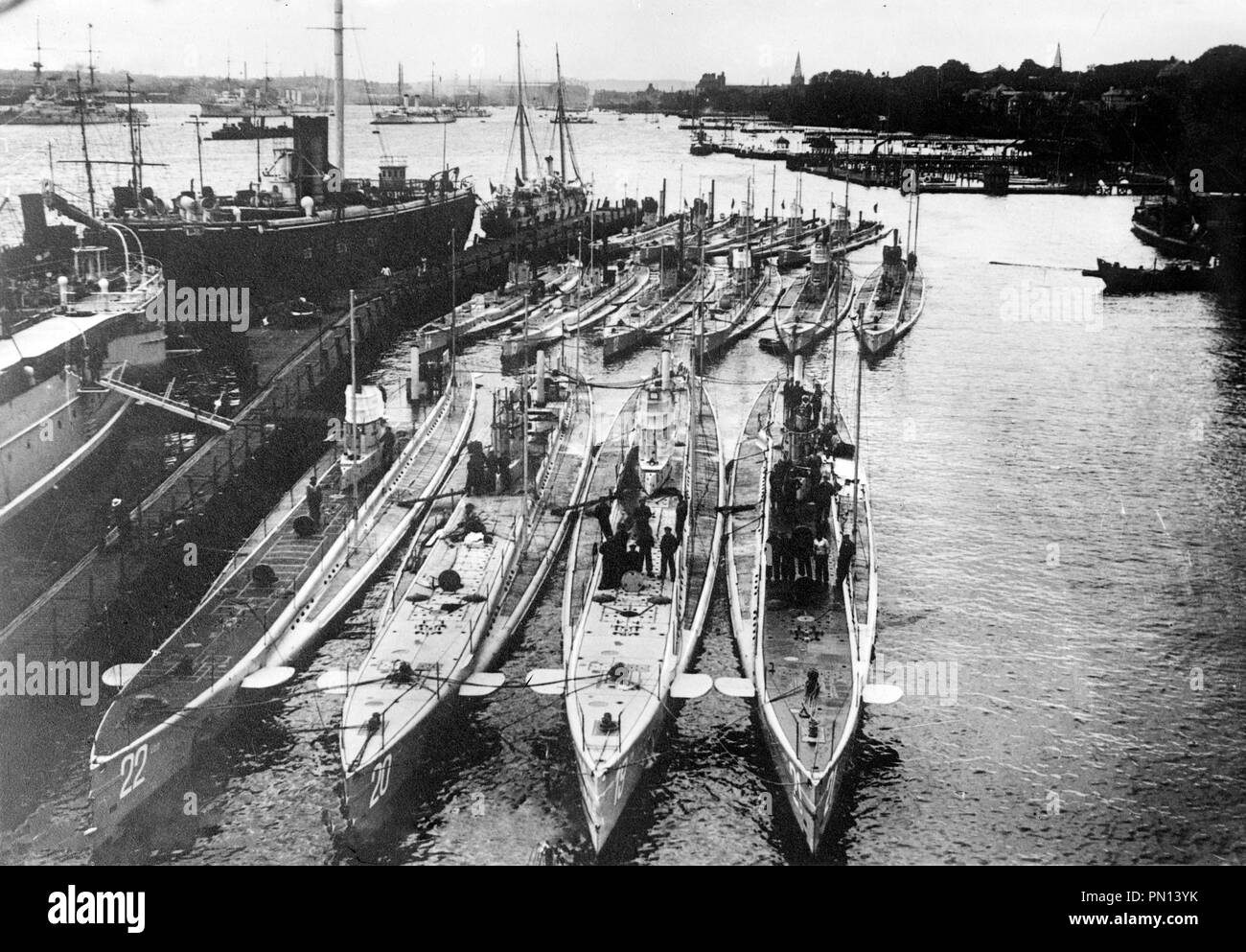 German Submarines in harbor. German submarines in a harbour. Front row (left to right): U-22, U-20 (sank the Lusitania), U-19 and U-21. Back row (left to right): U-14, U-10 and U-12 Stock Photo