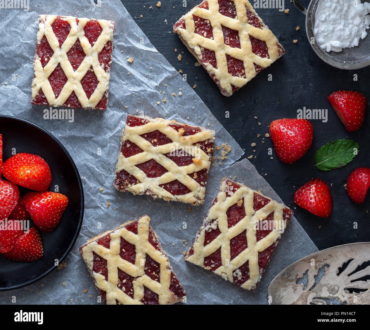 Strawberry cakes with strawberry fruits on dark background. Stock Photo