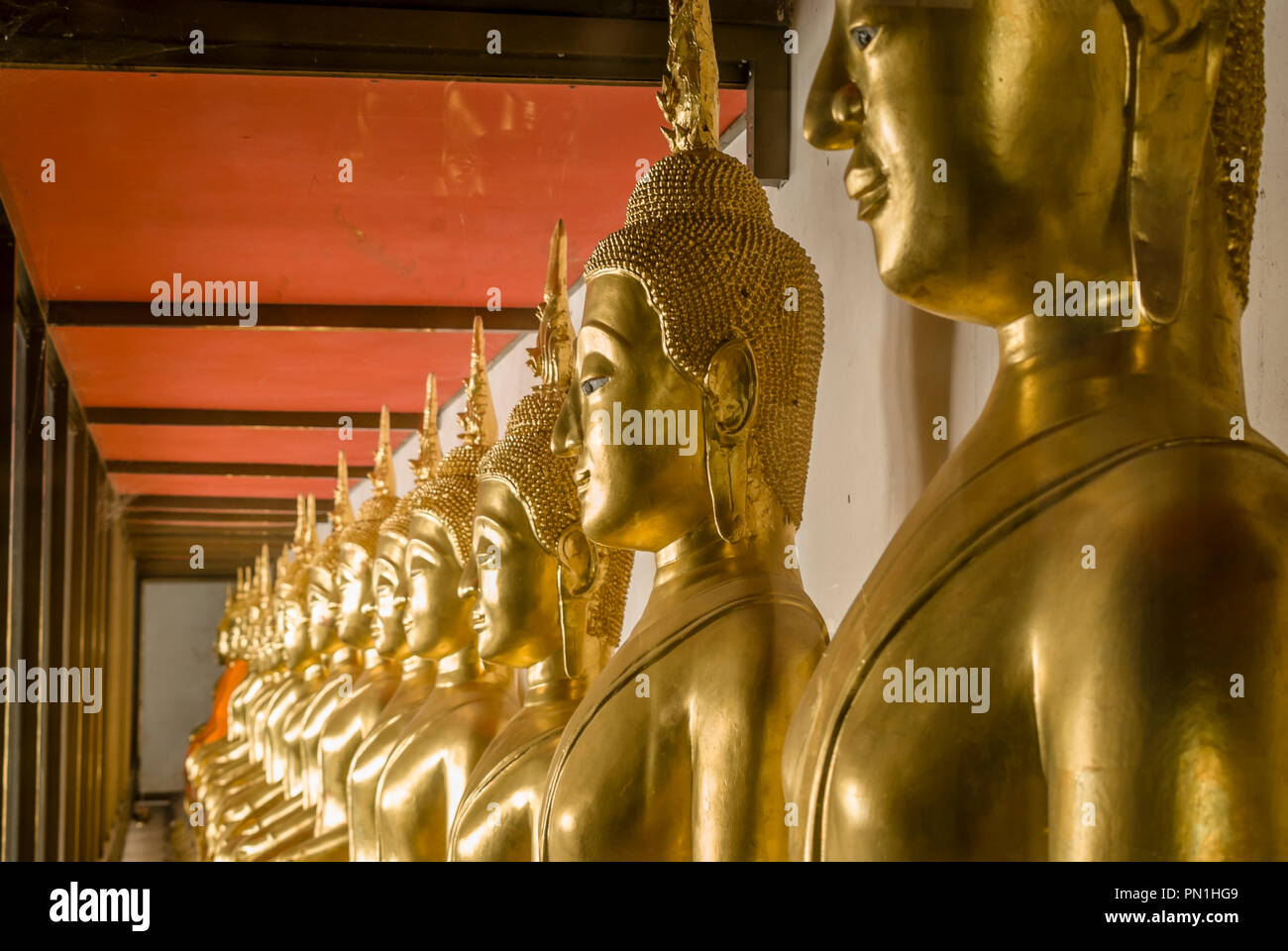 Row of Buddhas inside Wat Mahathat Worawihan Temple, Phetchaburi, Thailand Stock Photo