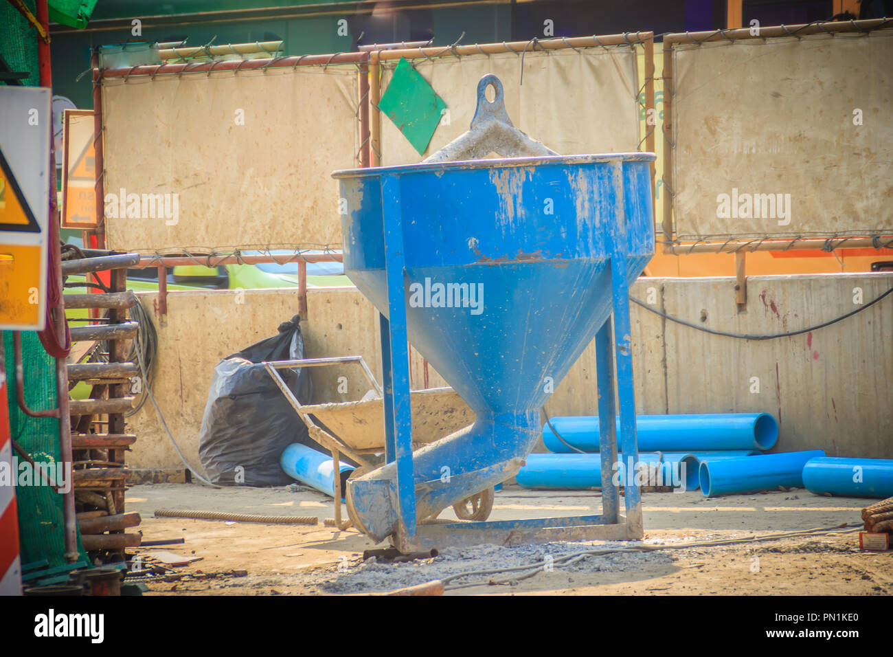 Blue concrete bucket, mixed cement container at the construction site