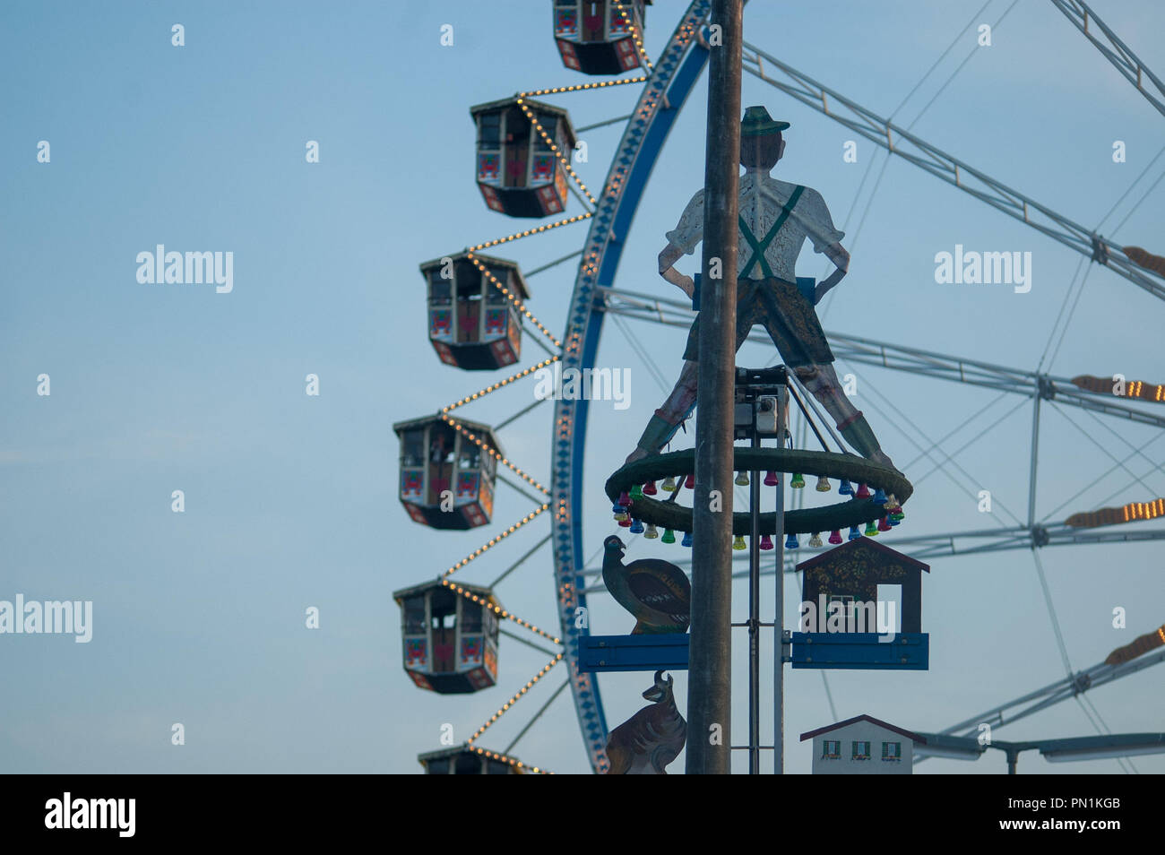 ring-the-bell attraction in front of Ferris wheel at Munich Oktoberfest ...
