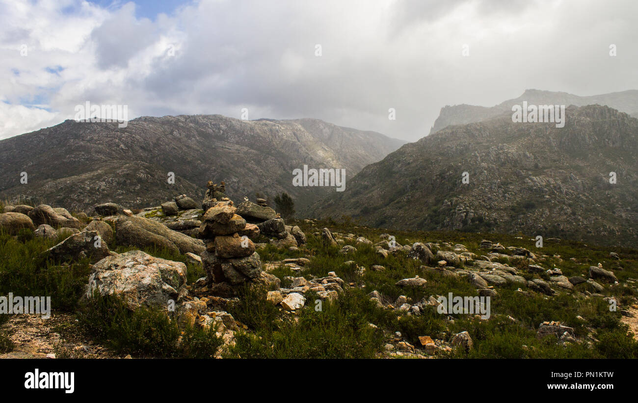 Rock formations acting as path markers in the mountains. Stock Photo