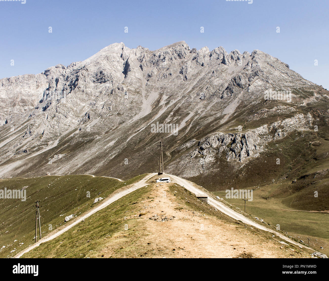 Road along the mountains on a clear day. Stock Photo