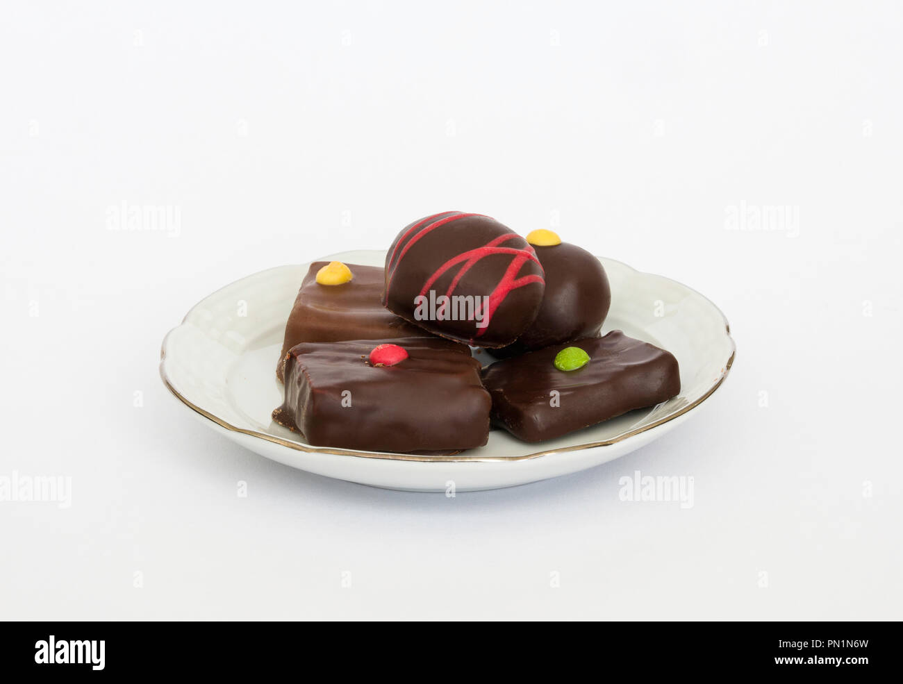 chocolate sweets on a dish with white background Stock Photo
