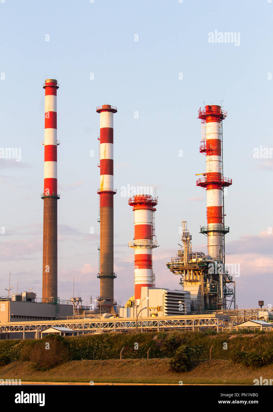 Capture of four industrial towers from a refinery, before sunset Stock