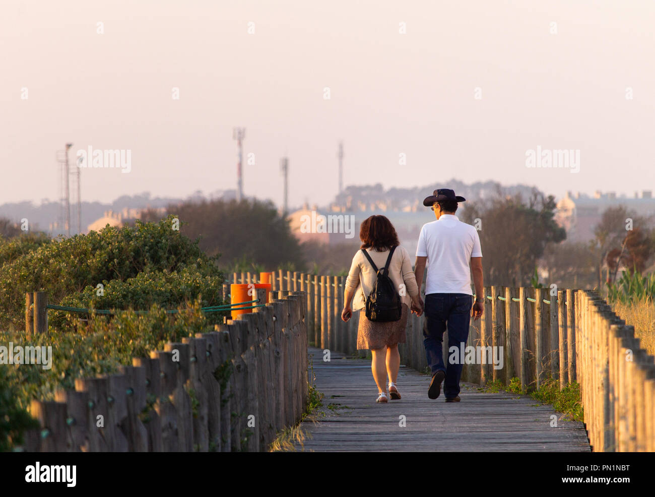 A middle-aged couple walks along a pathway. Stock Photo