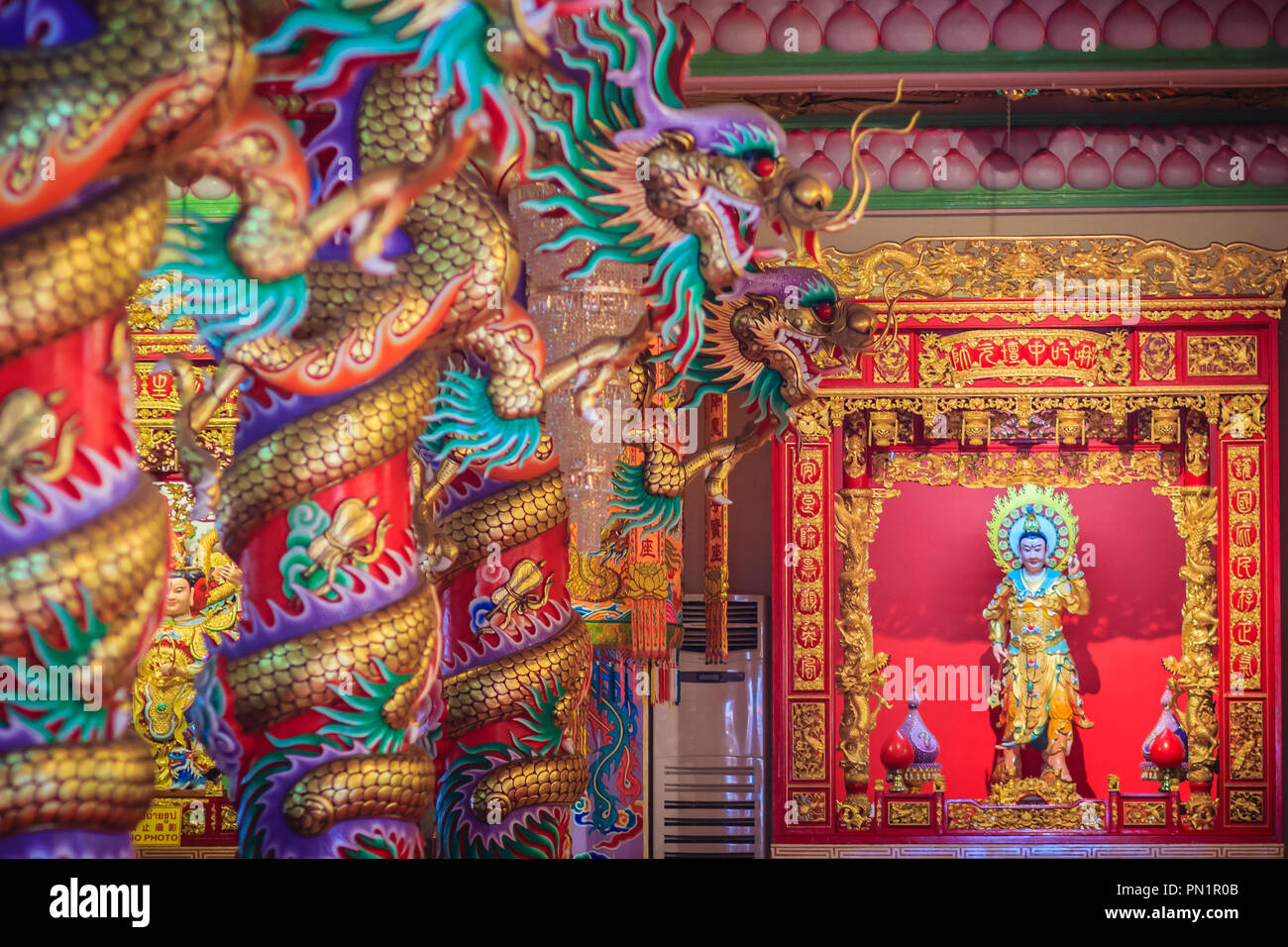 Colorful dragons and statue of Nezha, the protective deity in Chinese