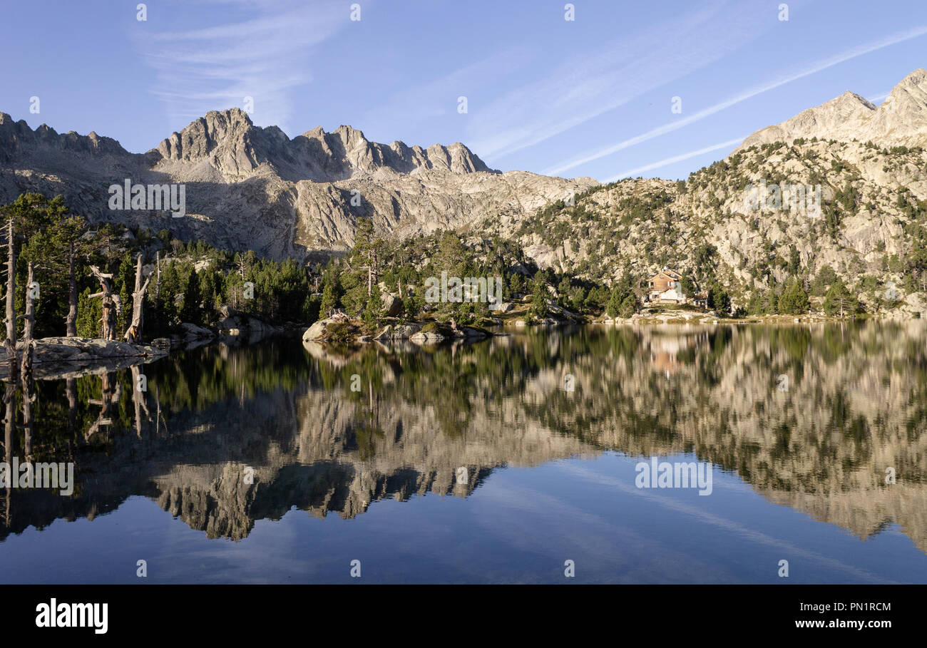 Panoramic view of a lake and the reflection of the rocky mountains. Stock Photo
