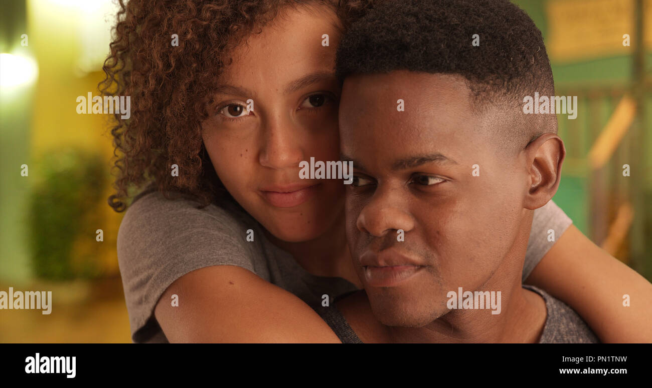 Close-up portrait of African American man and woman embracing each ...