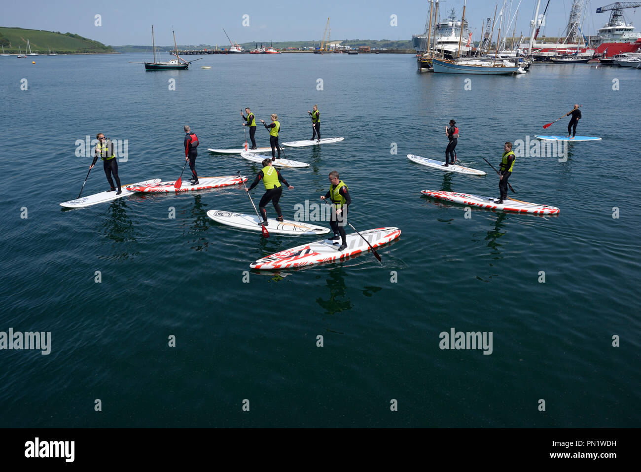 Paddle boarders in Falmouth Harbour, Cornwell, England Stock Photo
