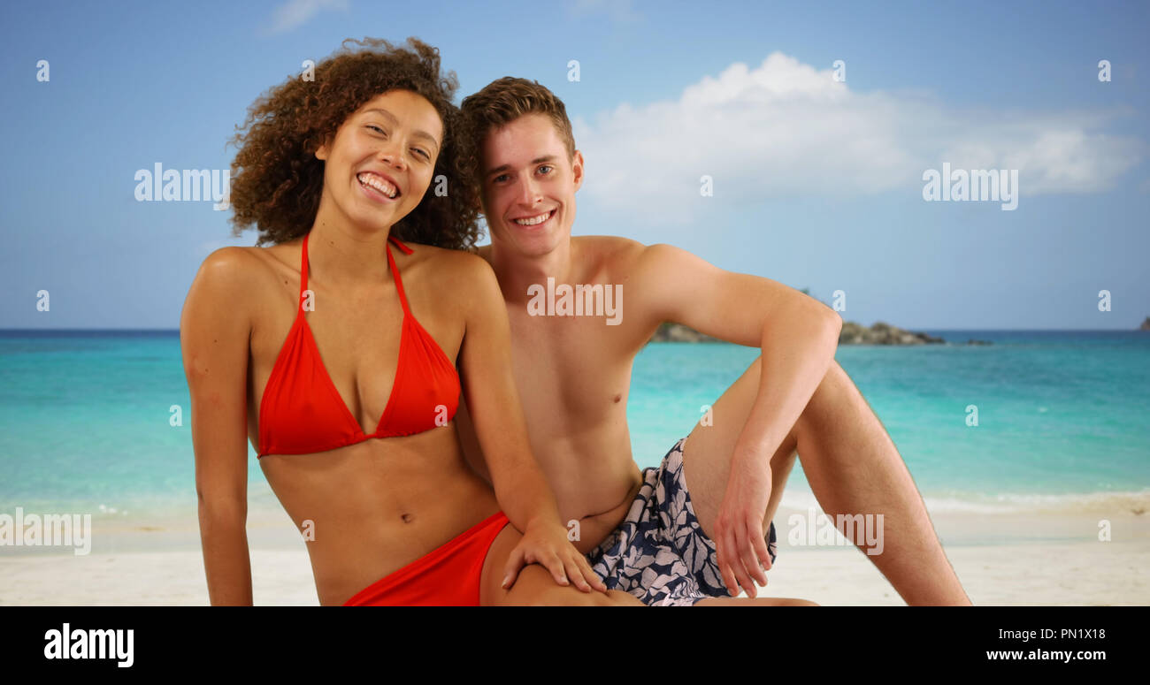 Attractive interracial friends posing on Caribbean beach Stock Photo image