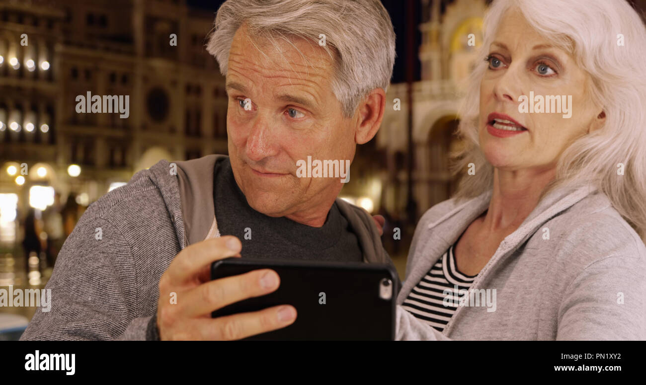 Mature couple arguing about directions in Venice Stock Photo