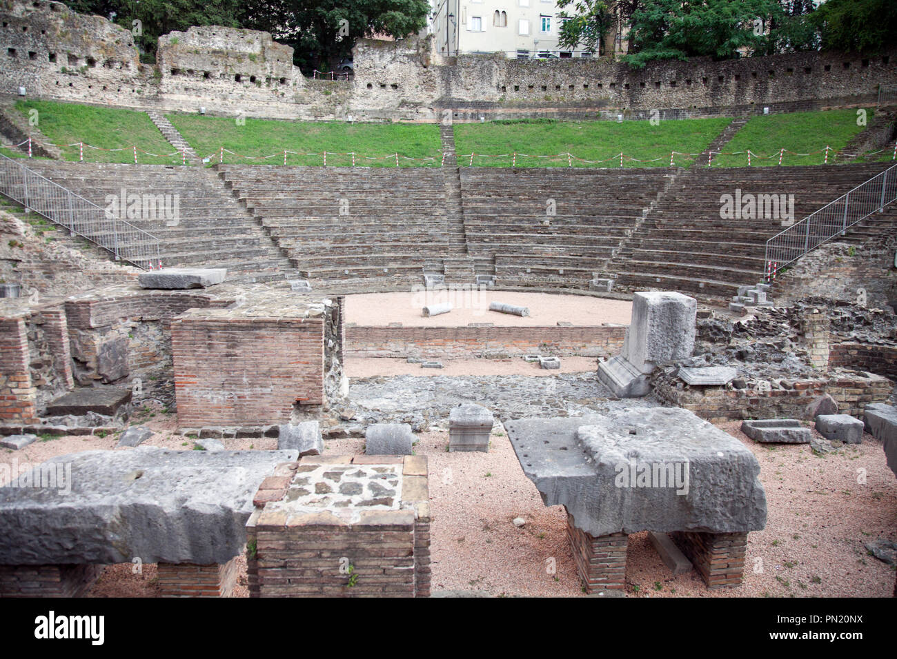 Discovered and excavated in the 1930s, Trieste's  Roman Theatre today nudges the city's commerical heart. The backing wall is original. Overall this a Stock Photo