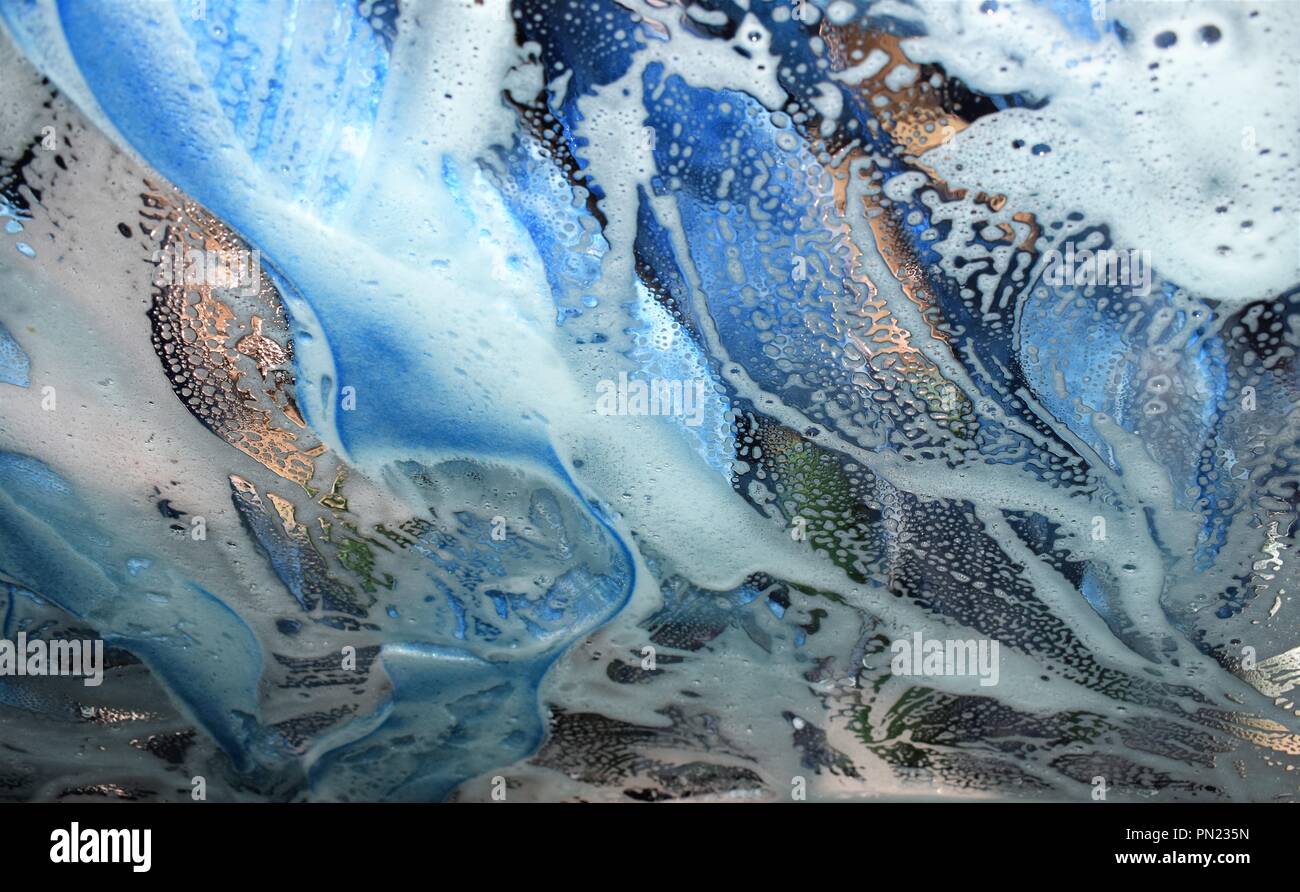 Close up of suds mixture of colors white, gold and blues Stock Photo