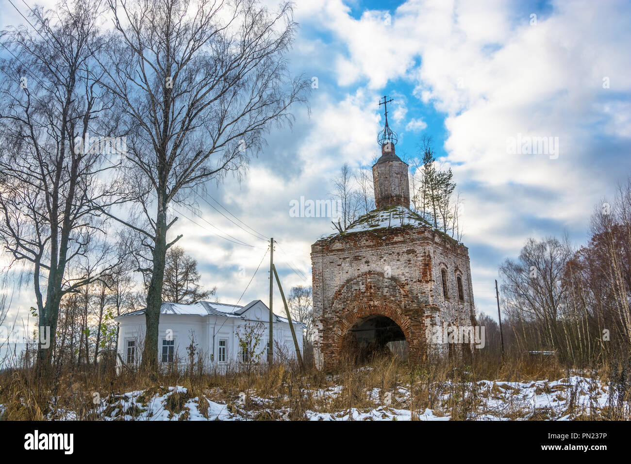 Village Khomutovo, Irkutsk oblast, Russia – November 18, 2017: the Ruins of ancient Orthodox Church and the new prayer house, November 18, 2017 in the Stock Photo