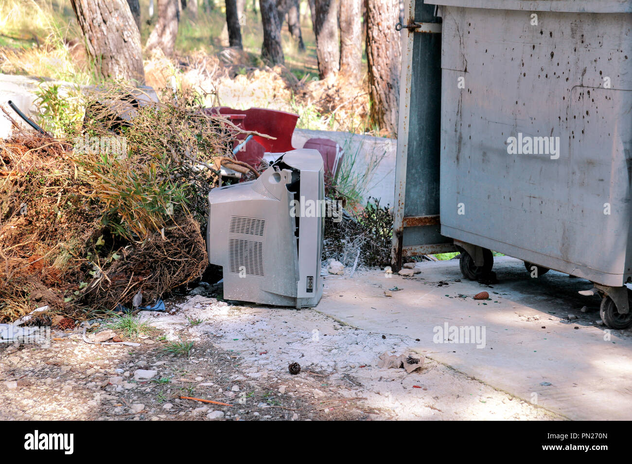 Discard old TV sets on a street, television near the garbage container