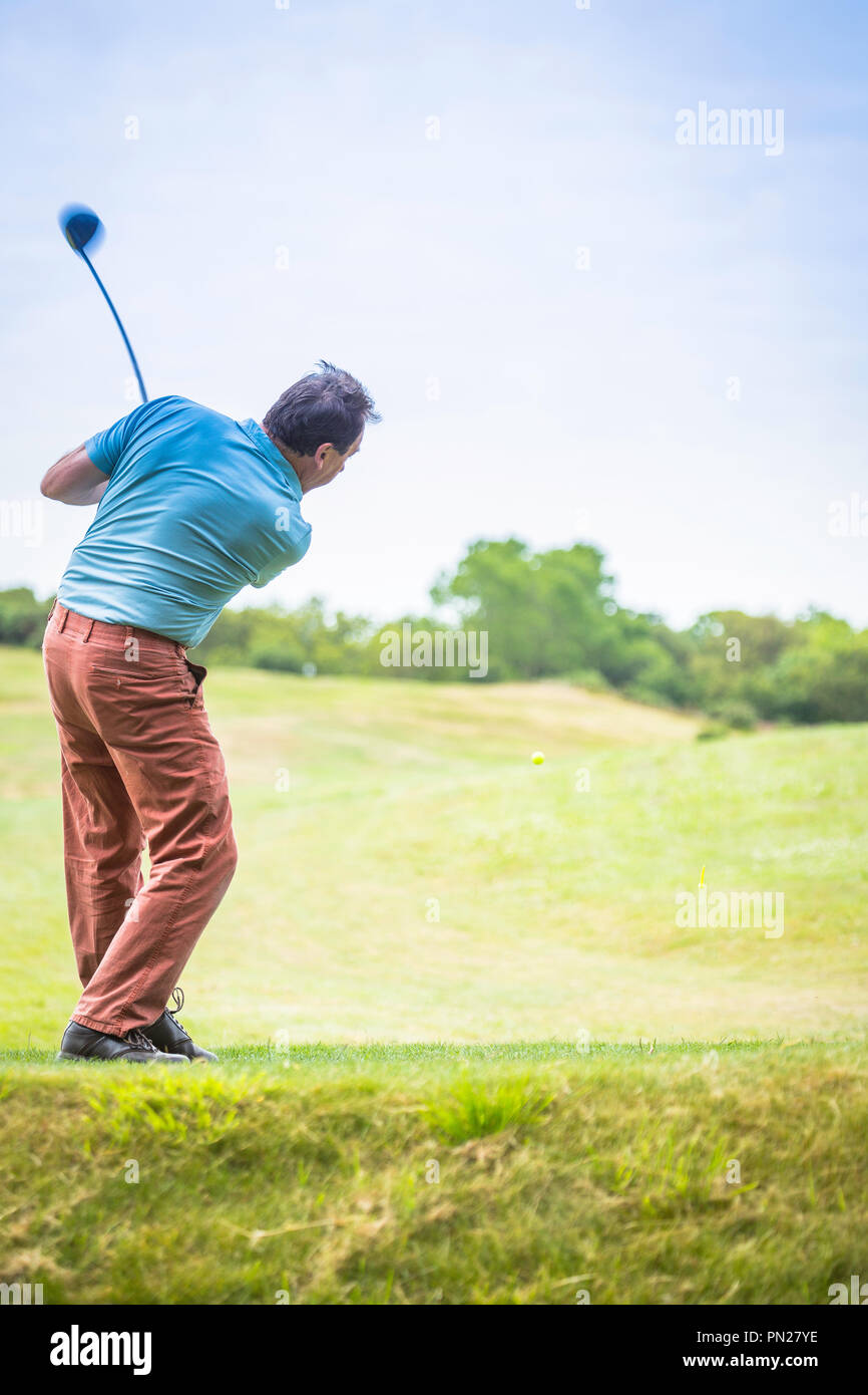 Golfer driving off from the tee Stock Photo Alamy