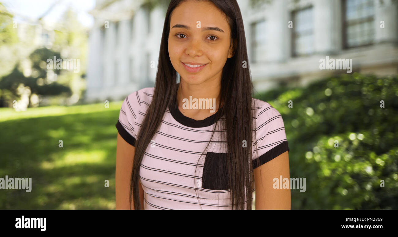 A young college girl poses outside of her university Stock Photo