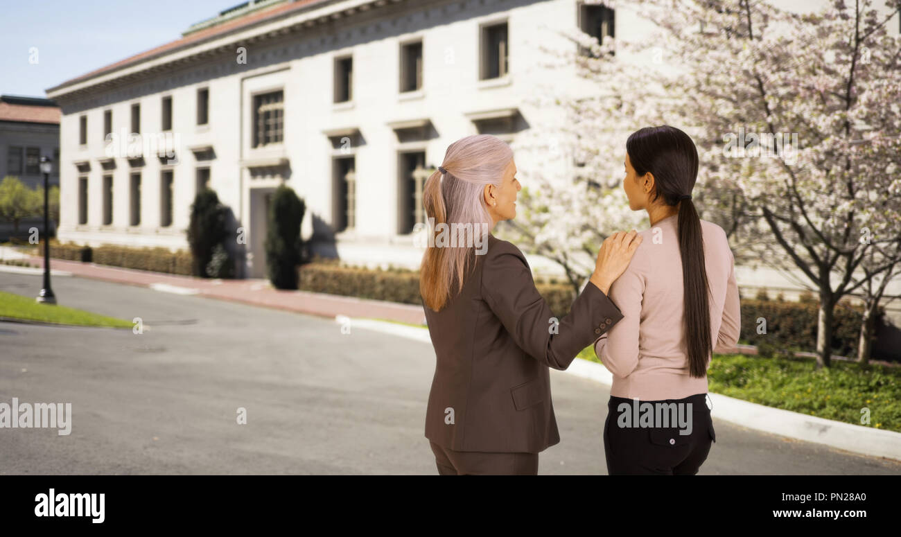 A professor advies a student on campus Stock Photo