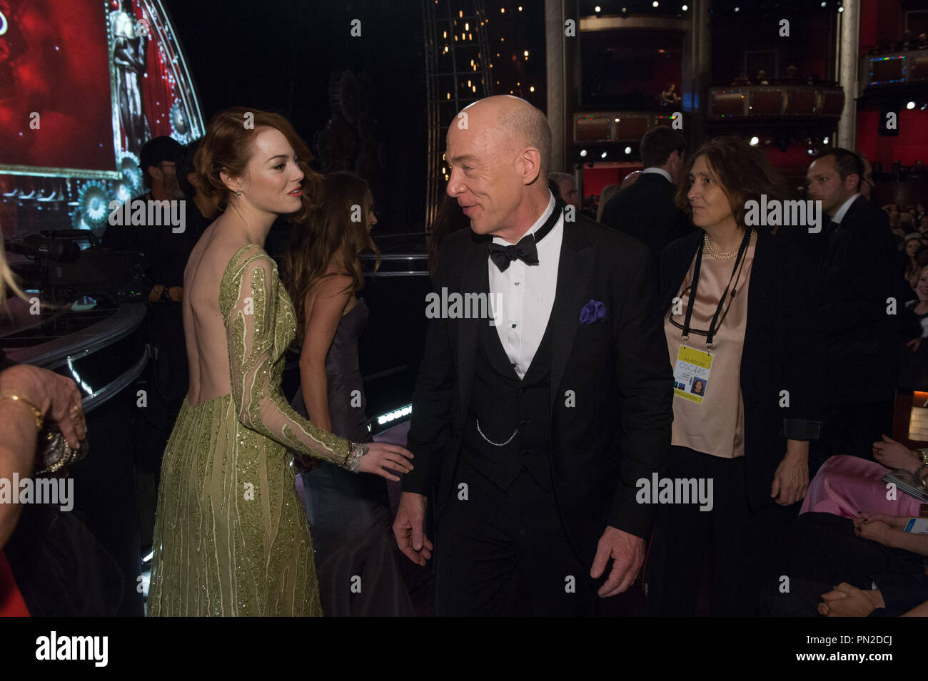 Emma Stone, Oscar® nominee for Achievement for Actress in a Supporting Role, for work on “Birman (The Unexpected Virtue of Ignorance)” interacts with J.K. Simmons, Oscar® nominee for Achievement for Actor in a Supporting Role, for work on 'Whiplash,' during the live ABC Telecast of The 87th Oscars® at the Dolby® Theatre in Hollywood, CA on  Sunday, February 22, 2015.    File Reference # 32569 030THA  For Editorial Use Only -  All Rights Reserved Stock Photo