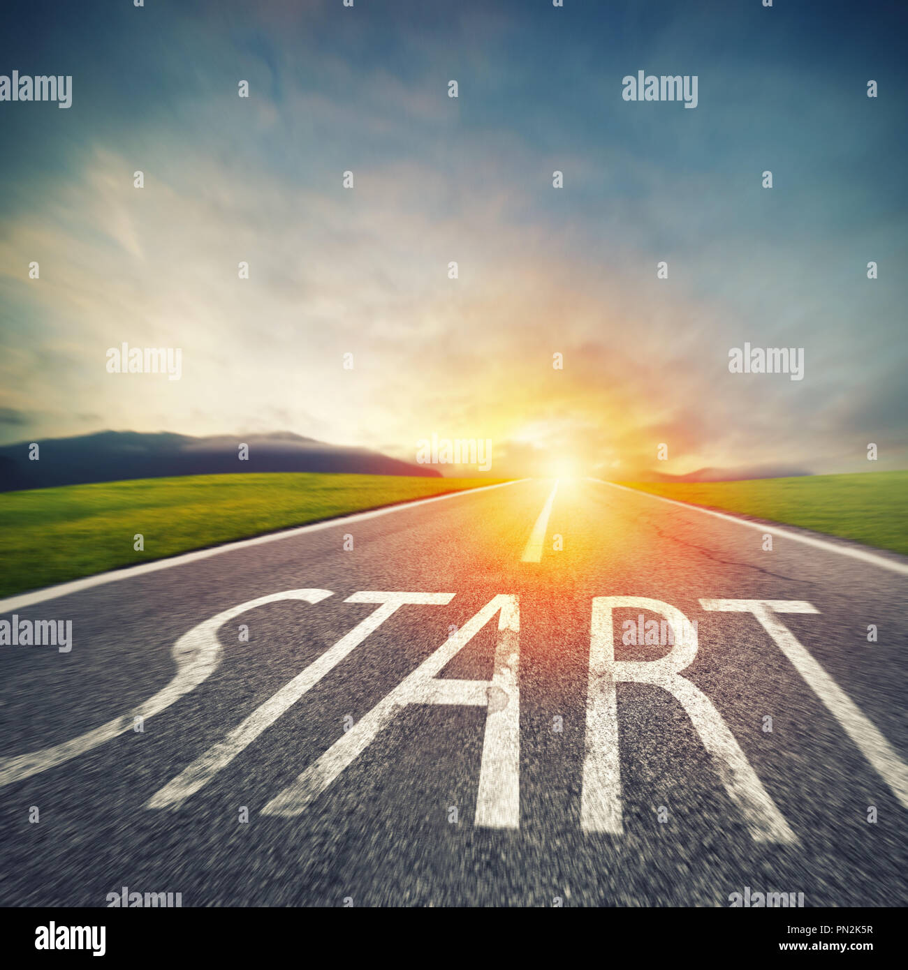 Start written to the ground on a road at sunset. Concept of new beginning and starting new opportunities Stock Photo